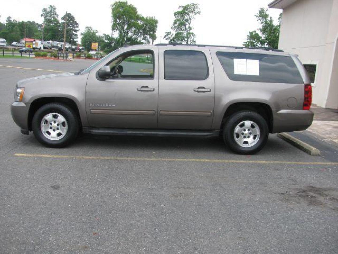 2011 Brown Chevrolet Suburban 1500 LS (1GNSCHE0XBR) with an Vortec 5.3L V-8 variable valve control engine, Automatic transmission, located at 2443 Albert Pike, Hot Springs, AR, 71913, (501) 623-6255, 34.492222, -93.109993 - Photo#1