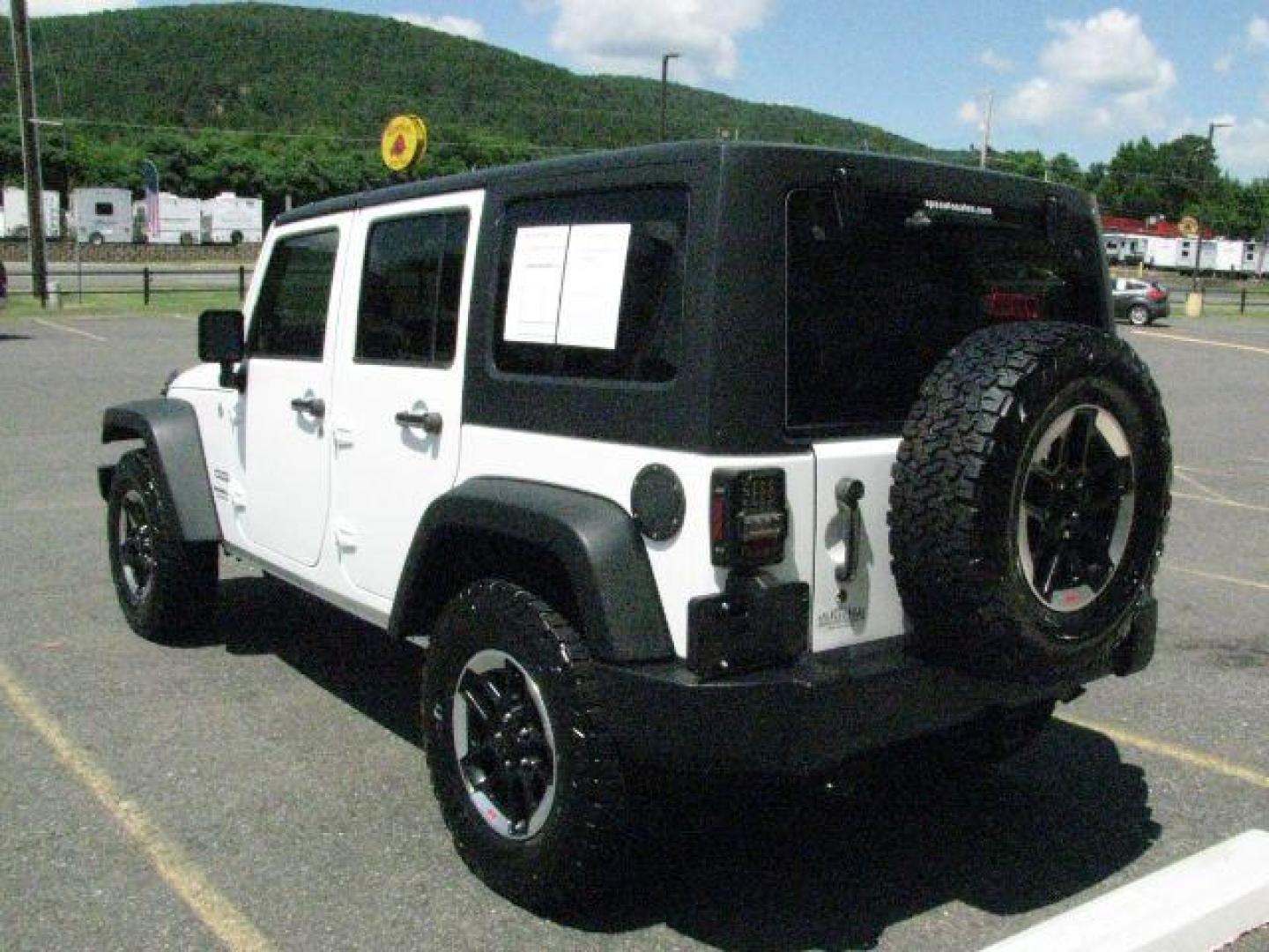 2014 White Jeep Wrangler Unlimited Sport (1C4BJWDG0EL) with an 3.6L V-6 DOHC engine, Automatic transmission, located at 2443 Albert Pike, Hot Springs, AR, 71913, (501) 623-6255, 34.492222, -93.109993- Photo#2